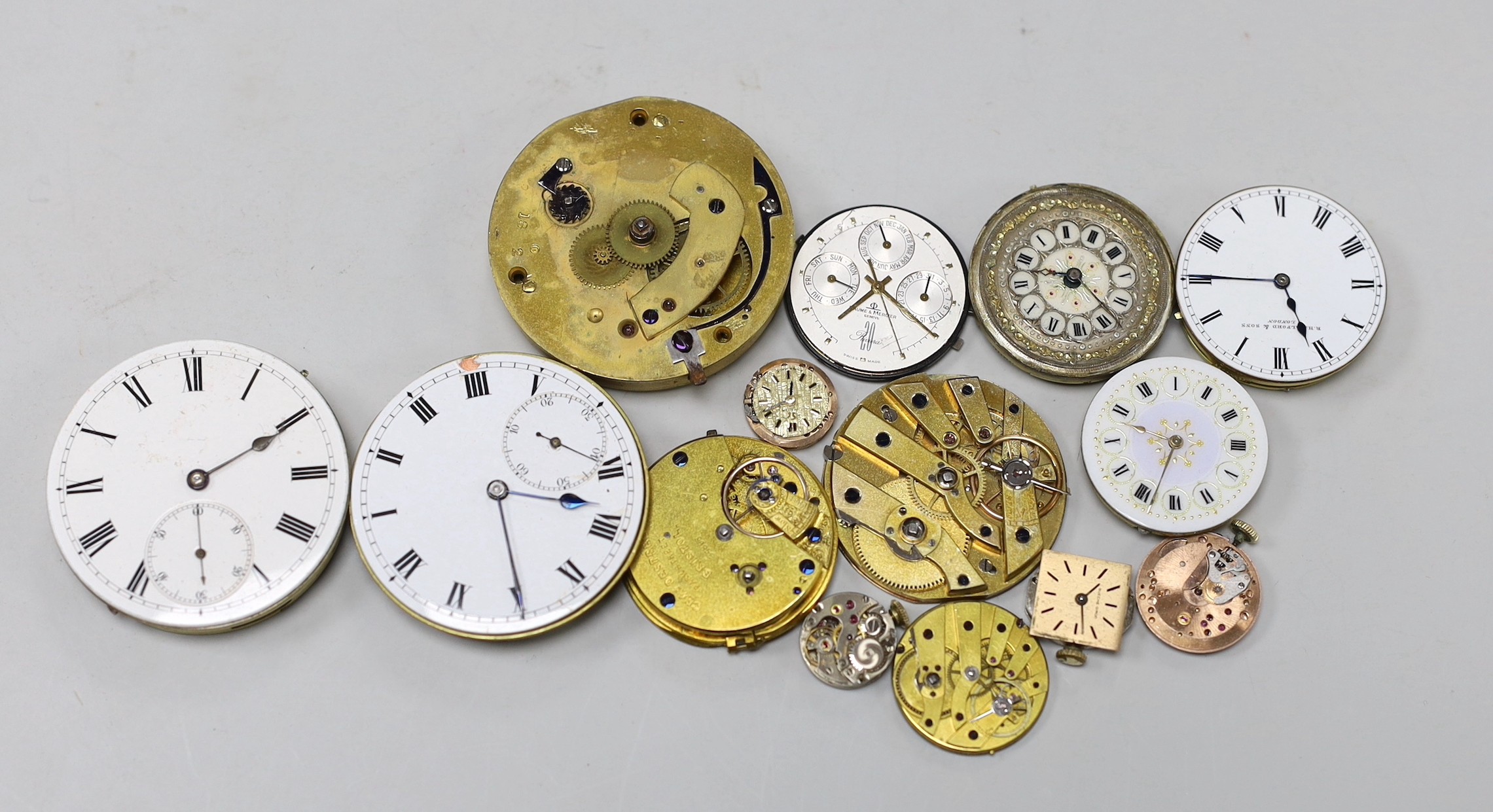 Various pocket and wrist watch movements and dials.